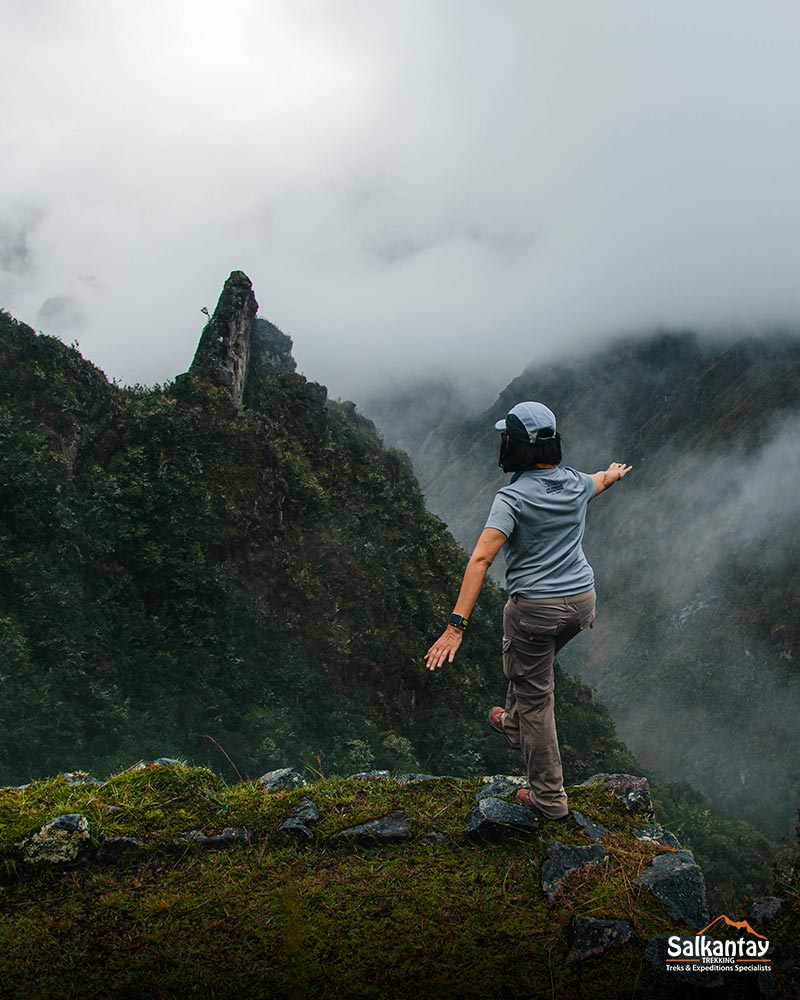 Female tourist looking at the impressive landscape of the Inca trail.