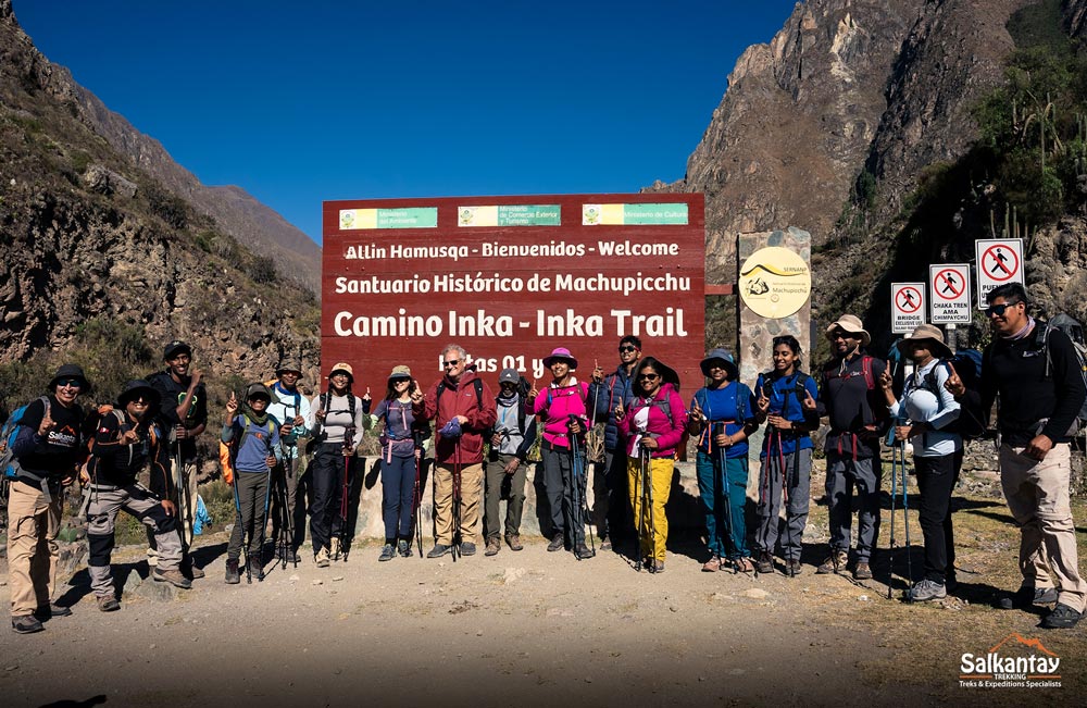 Group of tourists at km 82, the start of the classic Inca trail to Machu Picchu.