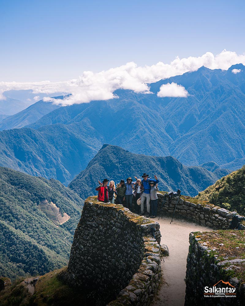 Group of tourists at the archaeological site of Phuyupatamarka against the background of mountains.