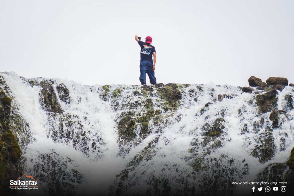 Man taking a selfie and waterfall
