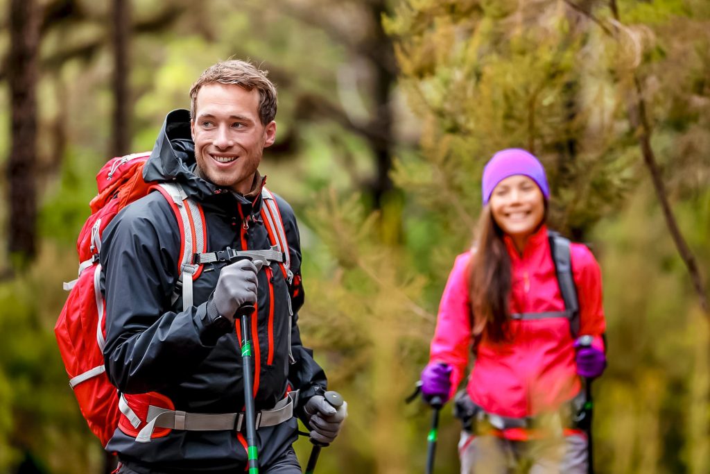 A cheerful couple of tourists hiking