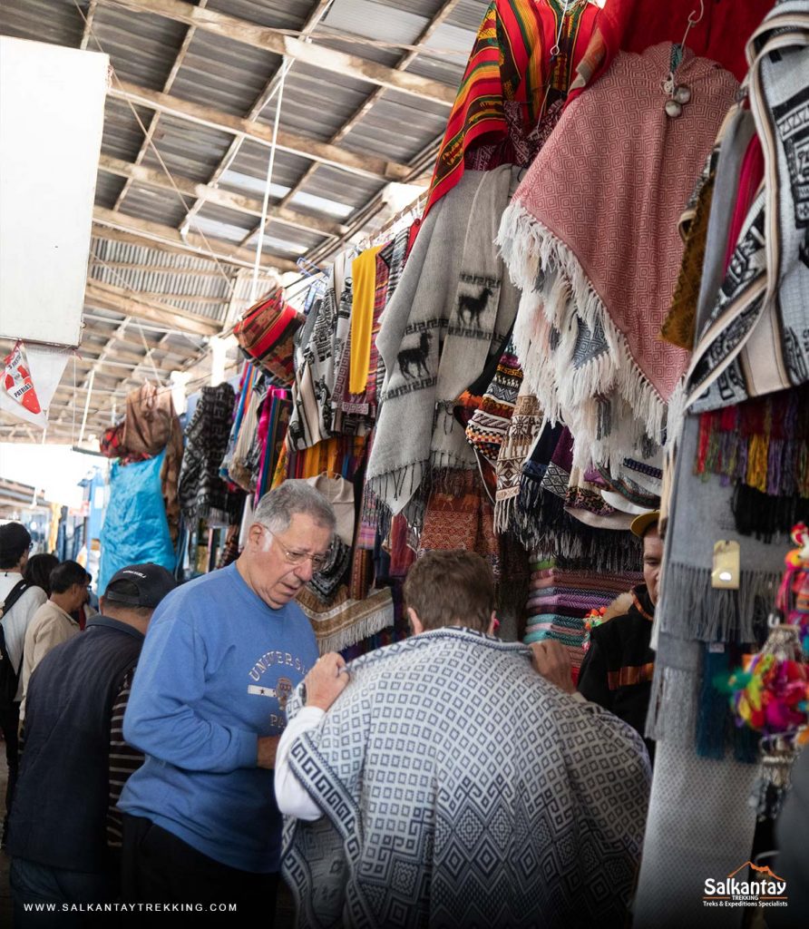 Tourists buying handicrafts in the San Pedro market of Cusco