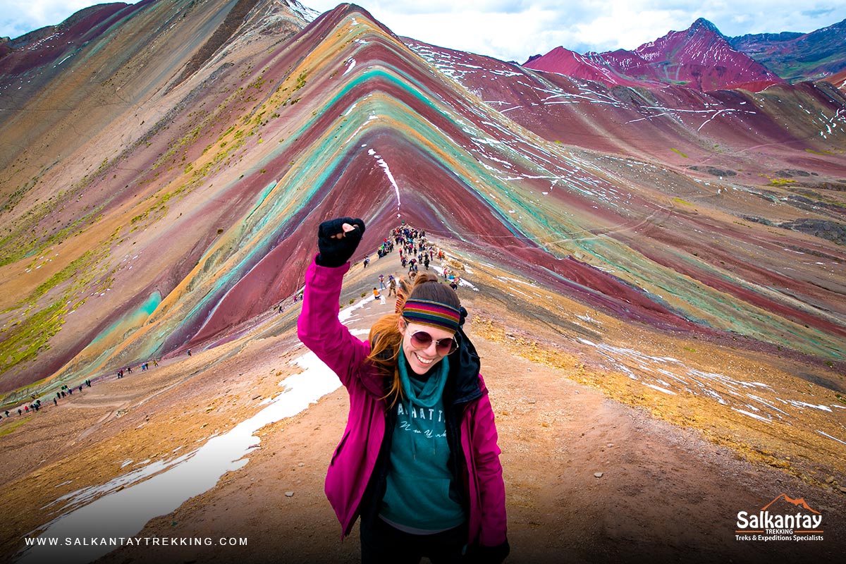 Tourist celebrating his arrival at the Rainbow Mountain at 5,000 meters above sea level