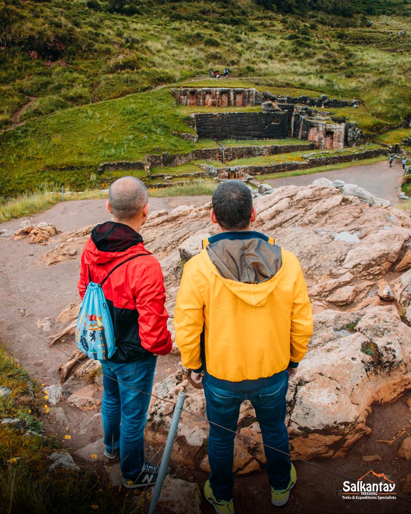 Two tourists viewing the archaeological site of Tambomachay