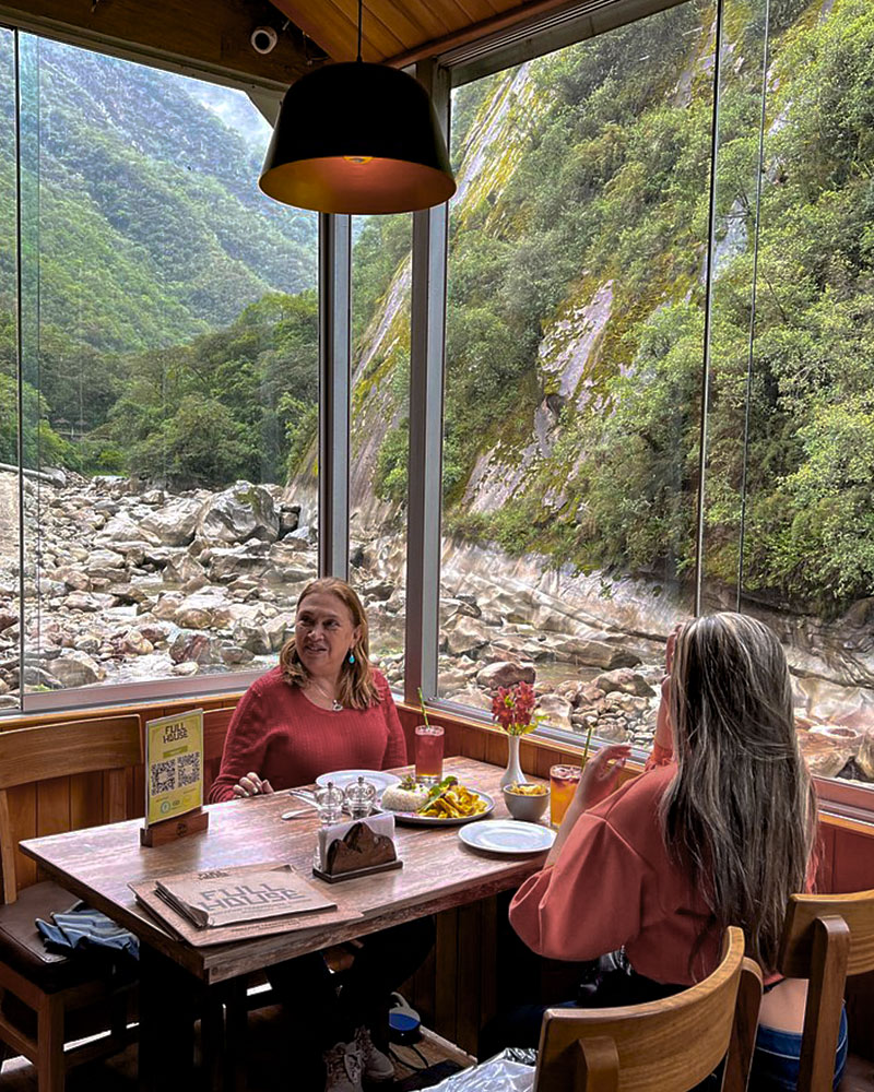 Two people eating at the Full House restaurant in Machu Picchu.