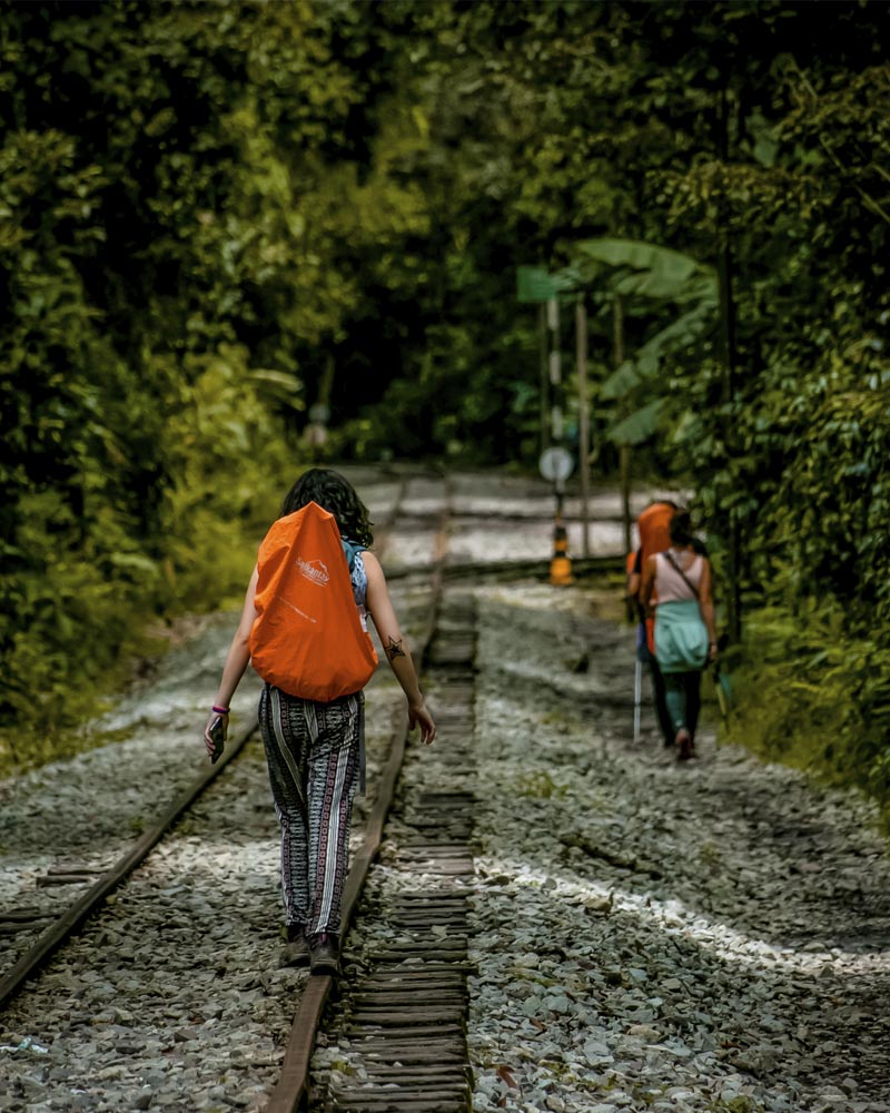 Tourists walking along the railroad tracks to Aguas Calientes village