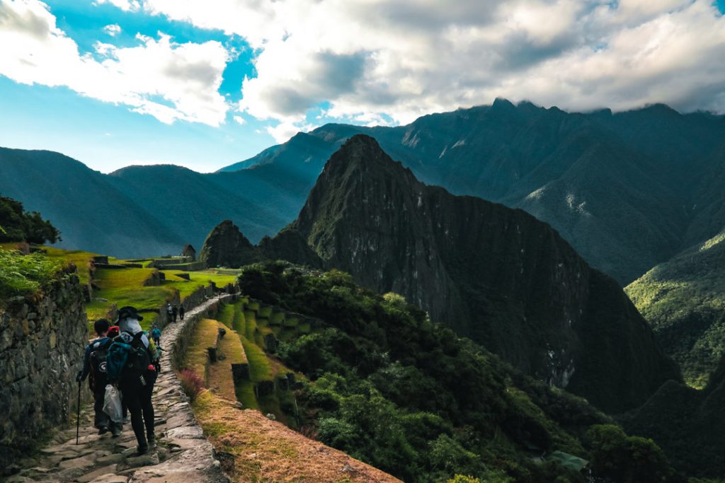 Tourist entering to Machu Picchu citadel from the Inca Trail