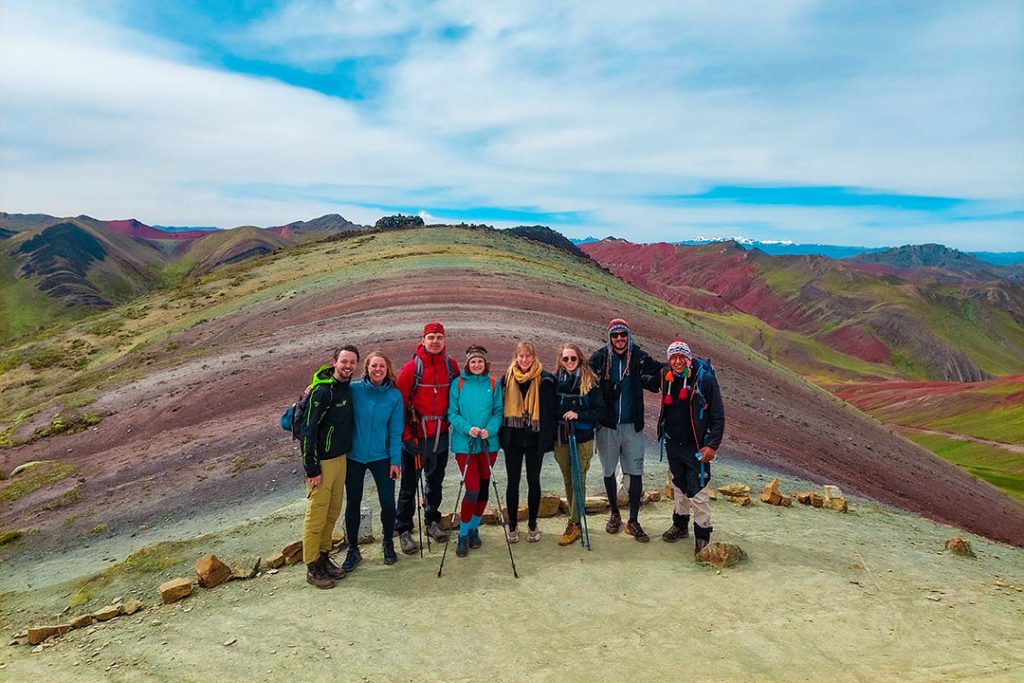 Group of tourists at the amazing Palccoyo Rainbow Mountain Cusco-Peru with their tour guide