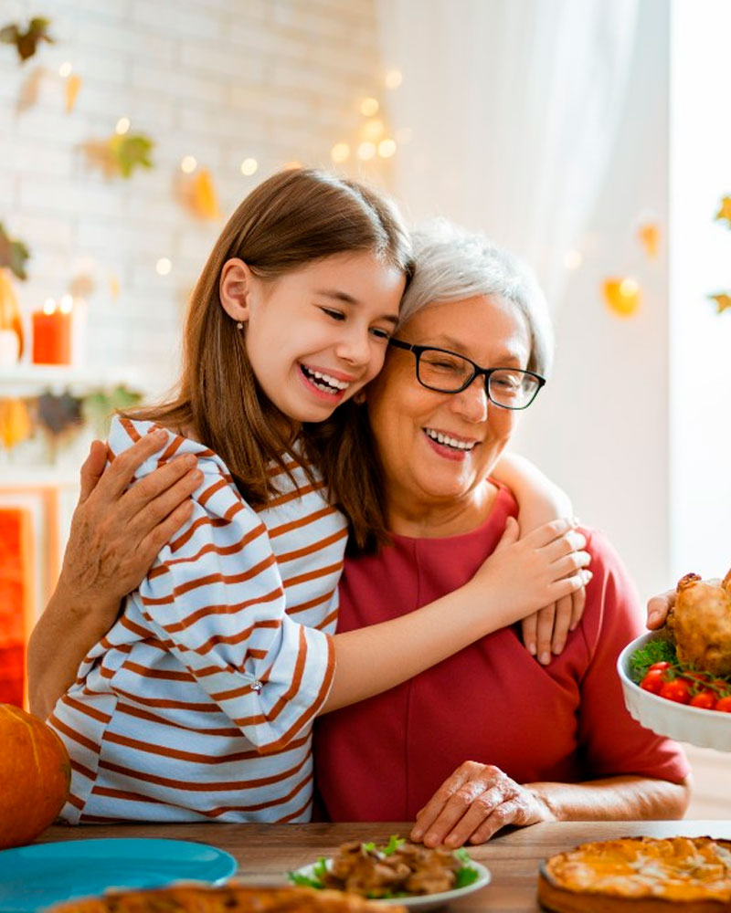 grandmother with her granddaughter at the thanksgiving dinner