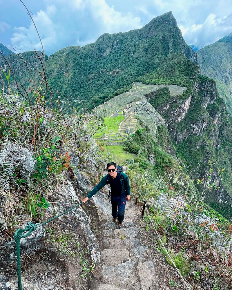 man walking up to the huchuy picchu mountain