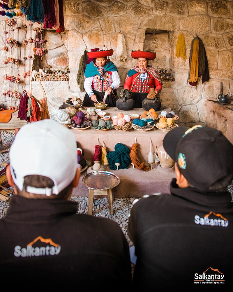 Guides watching the Andean weaving demonstration in Chincheros
