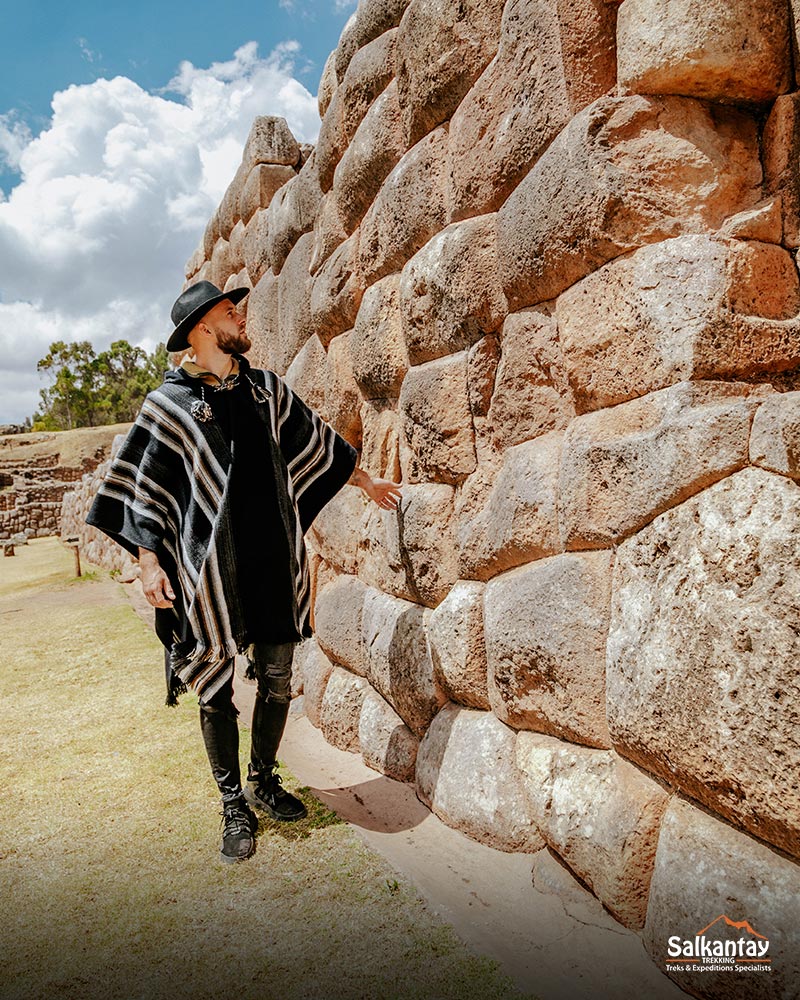 Tourist next to the stones of Chinchero archaeological site