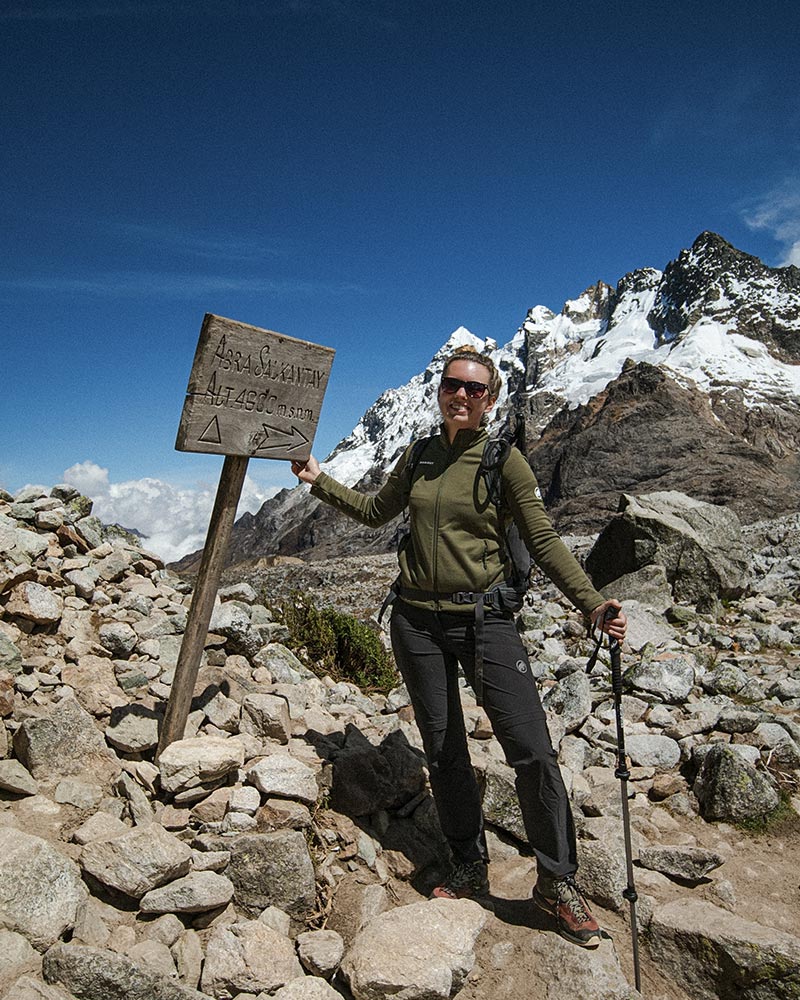 Tourist posing at Abra Salkantay on the Salkantay Trail