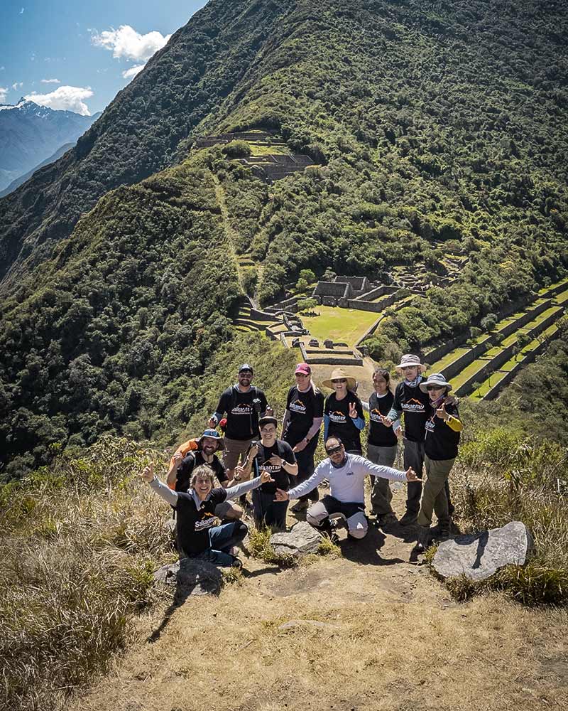 Tourists posing with the Choquequirao archaeological site in the background