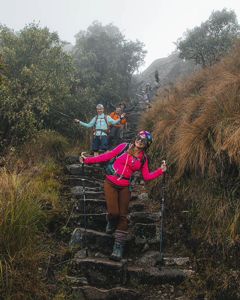 Tourists posing on the Inca Trail on their way to Machu Picchu