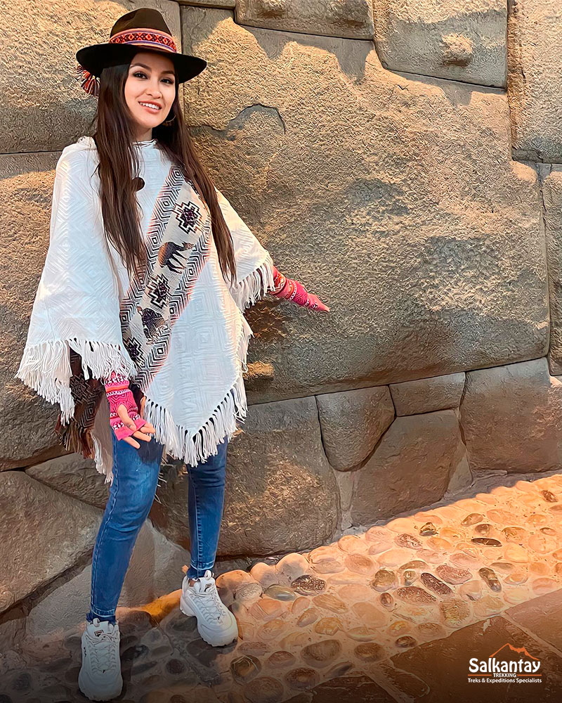 A woman in the piedra de los 12 angulos in Cusco Peru