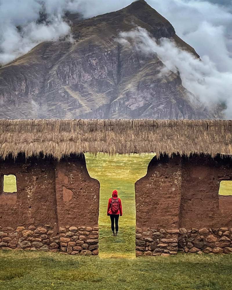 Woman touring the Inca archaeological site of Huchuy Qosqo