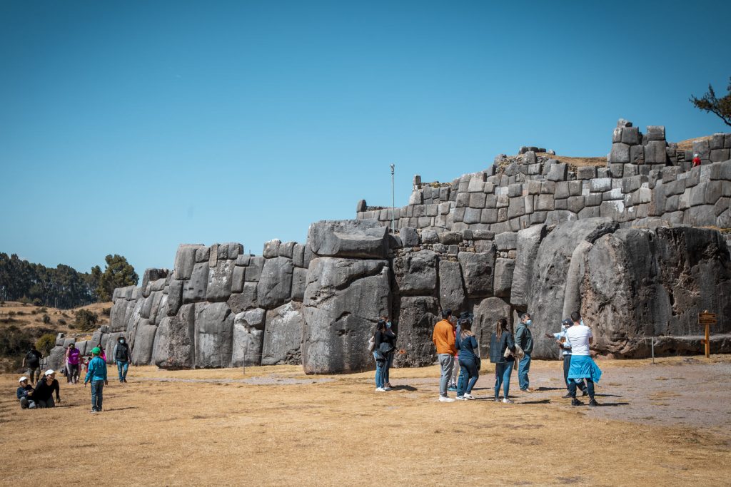 Tourists on the imposing cyclopean walls of Sacsayhuaman