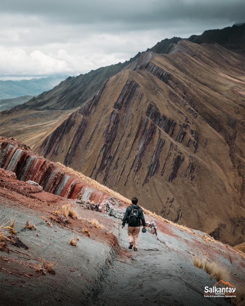 Tourist walking on the colorful mountain of Pallay Punchu