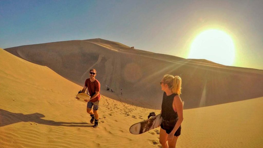 COUPLE PRACTICING SANDBOARDING - HUACACHINA, ICA 