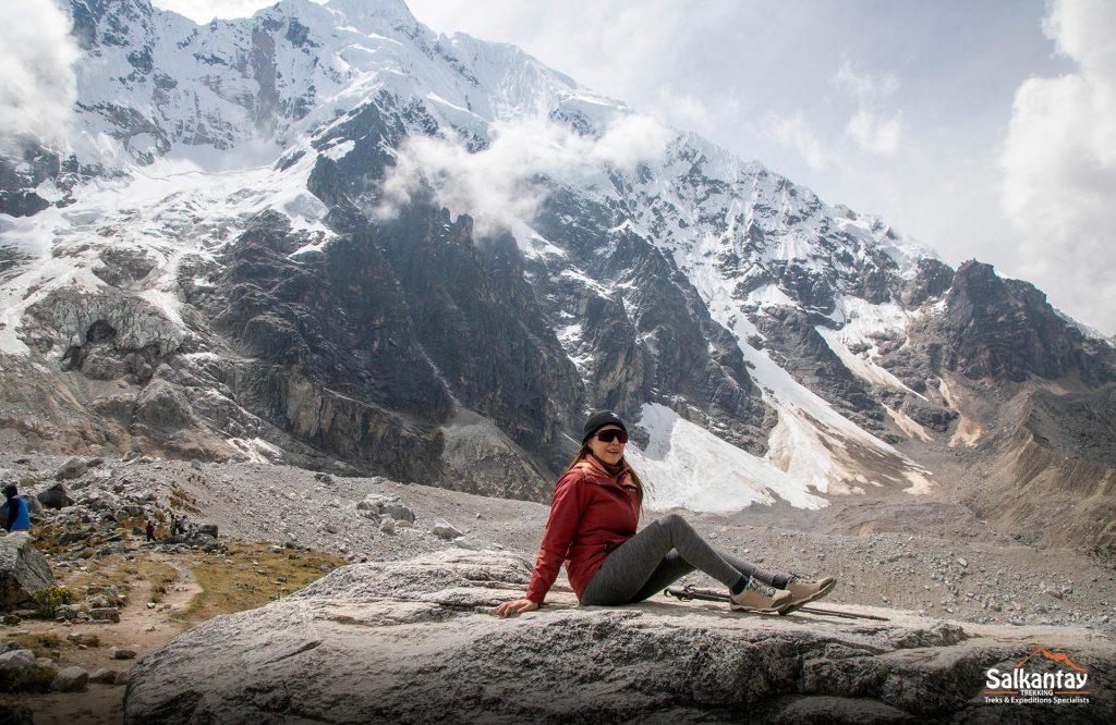 A girl in the mountains sitting and enjoying the nature of her surroundings in tranquility and peace