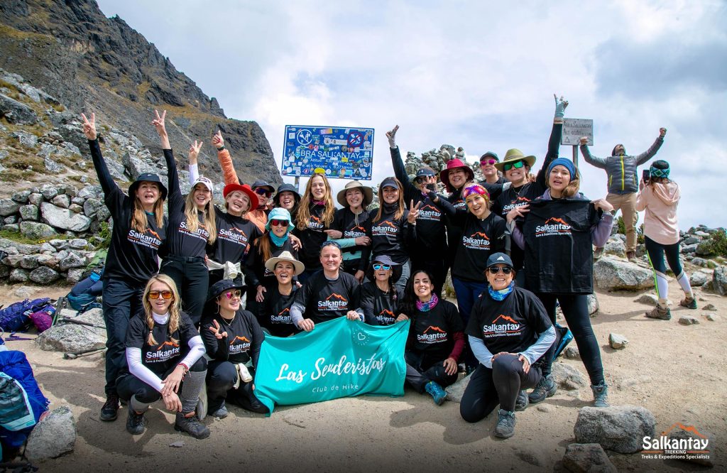 Image of women trekkers enjoying the top of a mountain.