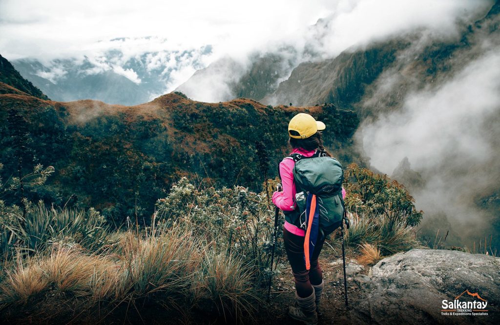 Panoramic photo of a tourist with her hiking gear