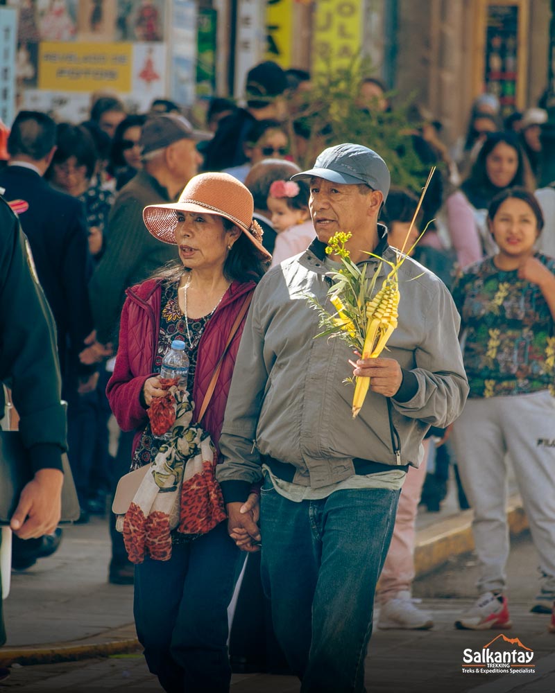 Photograph of a person holding an olive palm for blessing in Cusco's main square.