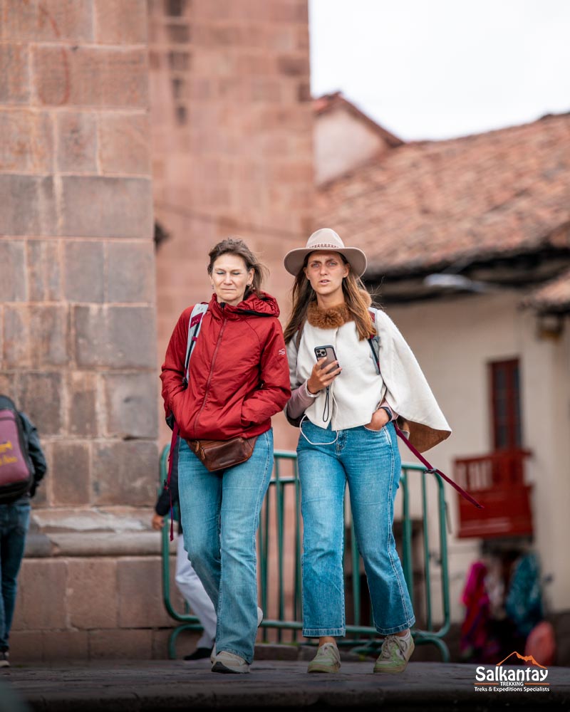 People walking and enjoying their day in Cusco's main square.