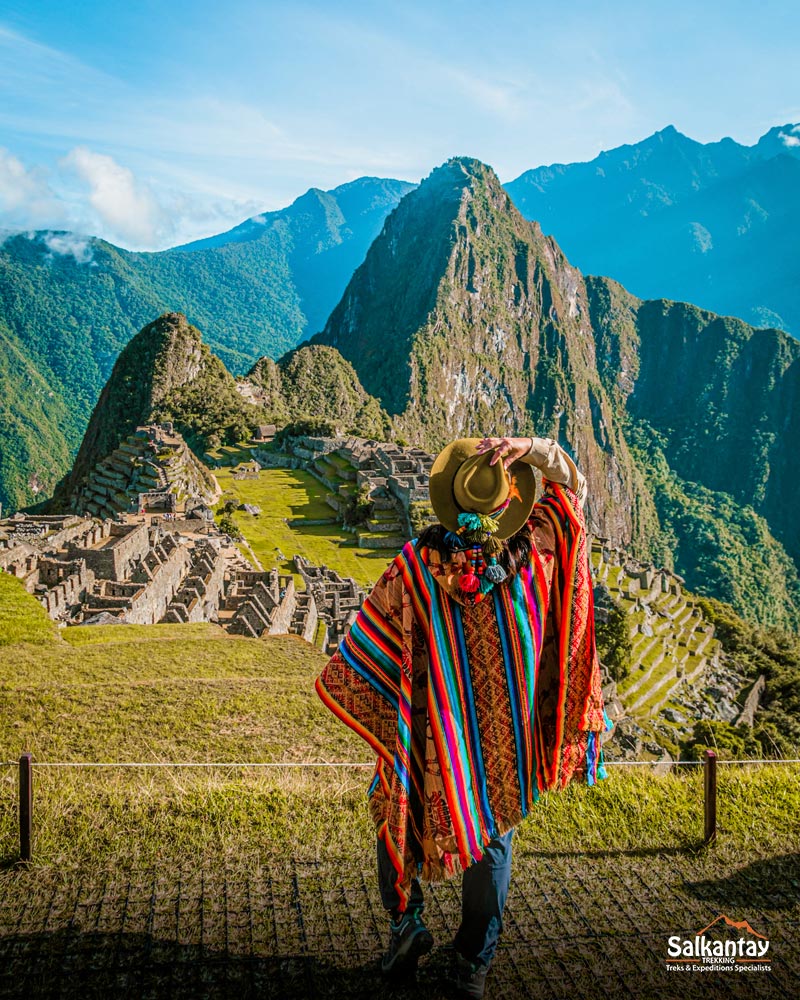 Tourist with colorful Andean poncho in Machu Picchu