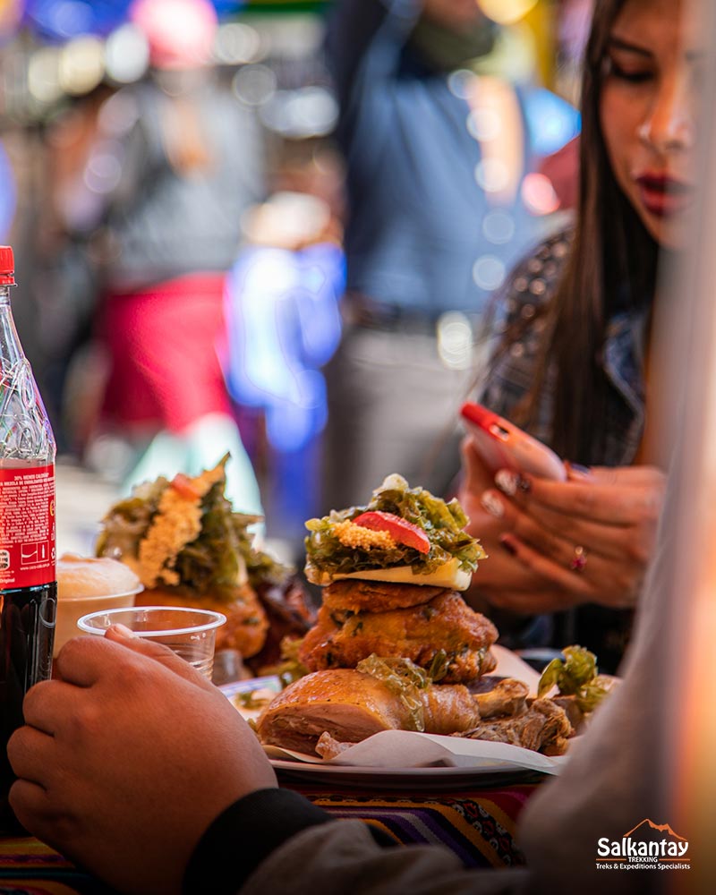 Tourist eating the typical dish of Cusco, the Chiriucho.