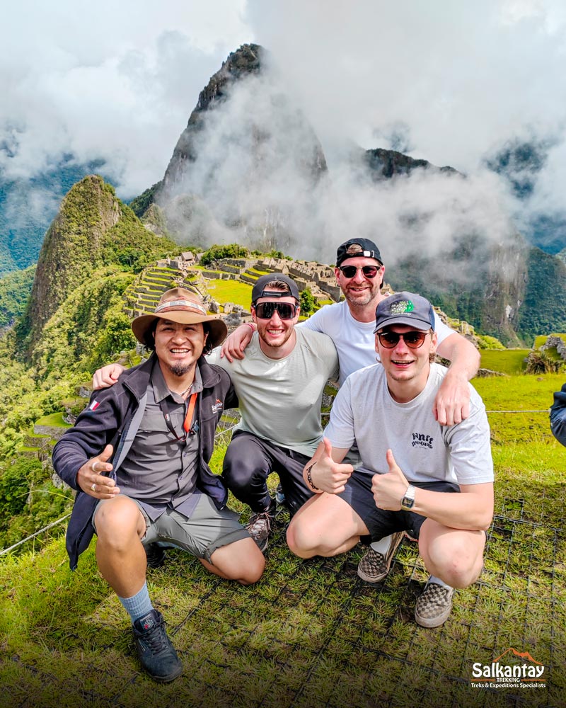 Tourists and their tour guide at the archaeological site of Machu Picchu