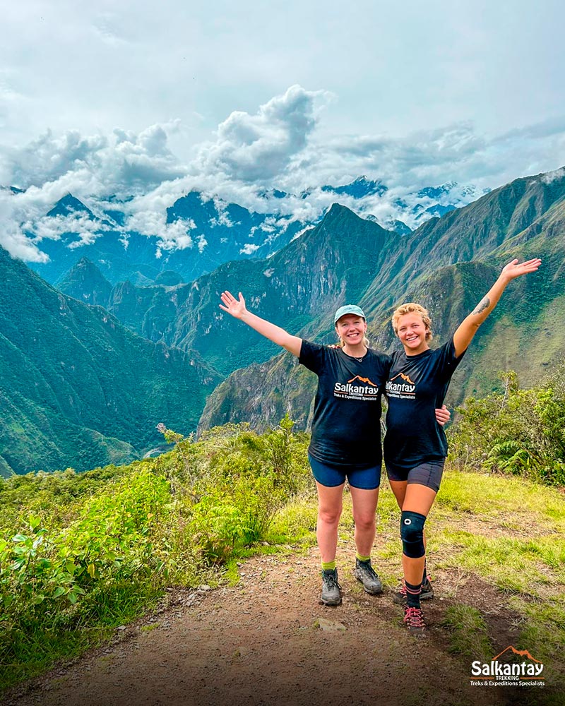 Two tourists at the archaeological site of Llactapata to have the first view of Machu Picchu.