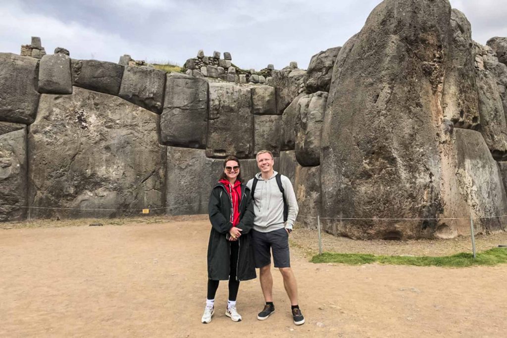 A couple taking a photo at Sacsayhuaman