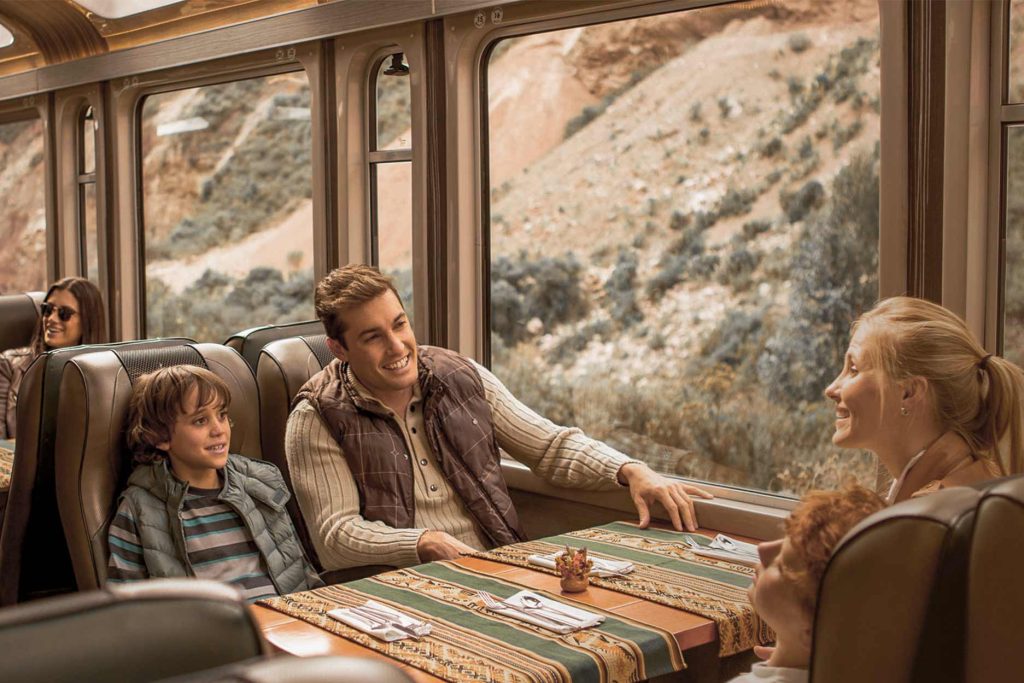A family enjoying the scenic train ride to Machu Picchu