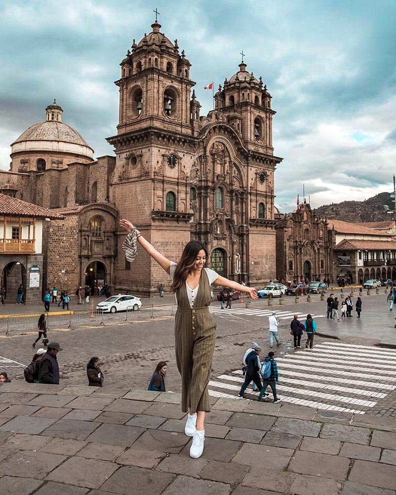 A happy tourist in the historic center of Cusco