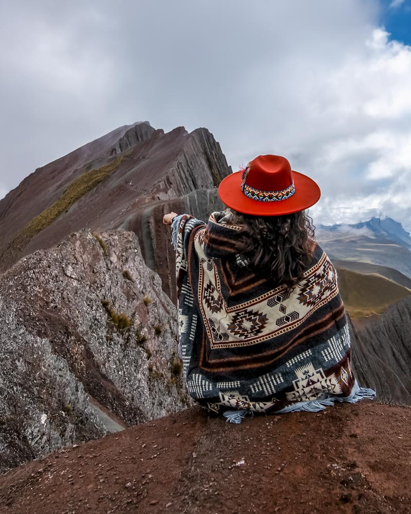 Tourist in Andean clothing on the colorful mountain of Pallay Punchu