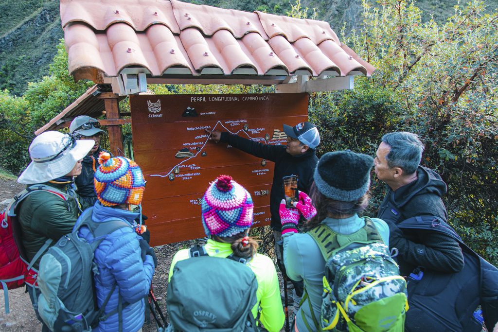 Guide explaining the route of the Inca Trail to a group of tourists