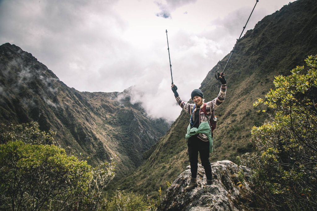 Woman posing happily in a landscape along the Inca Trail
