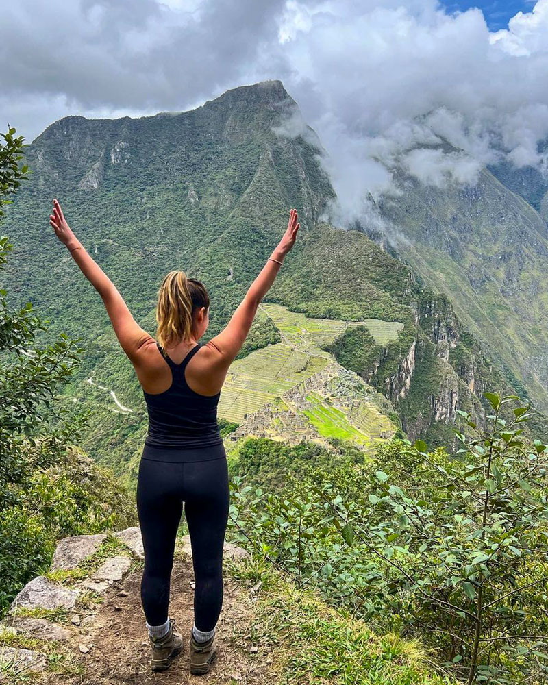 Woman posing at viewpoint Huayna Picchu
