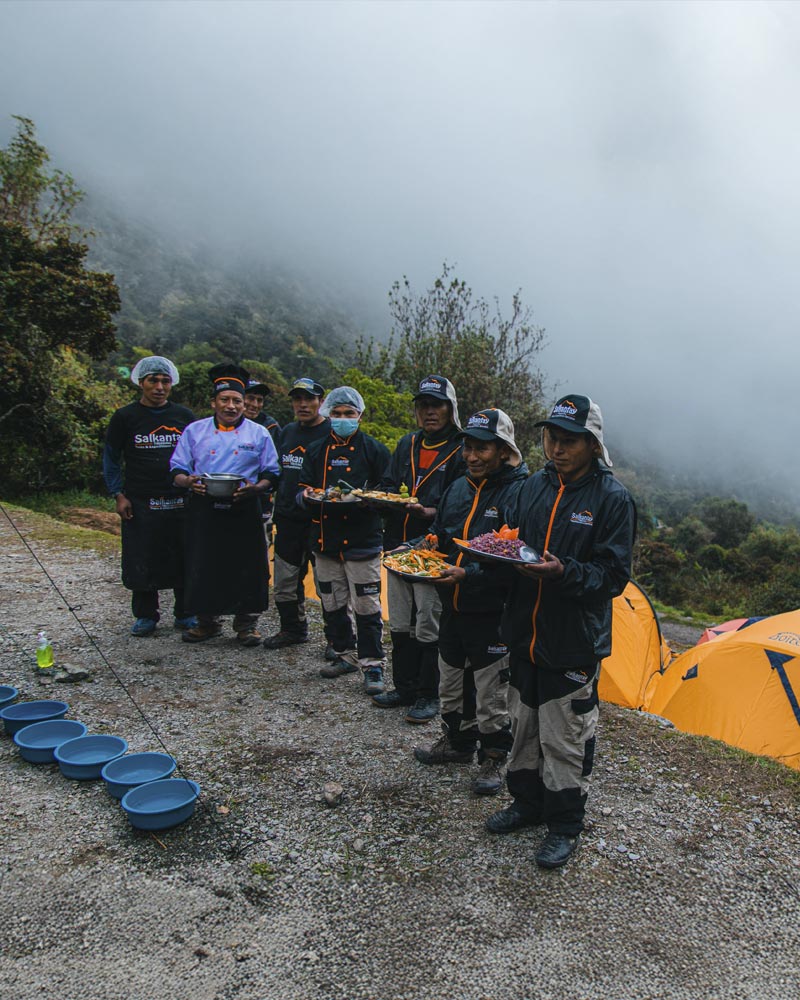 Cooks from Salkantay Trekking on the Inca Trail holding the food