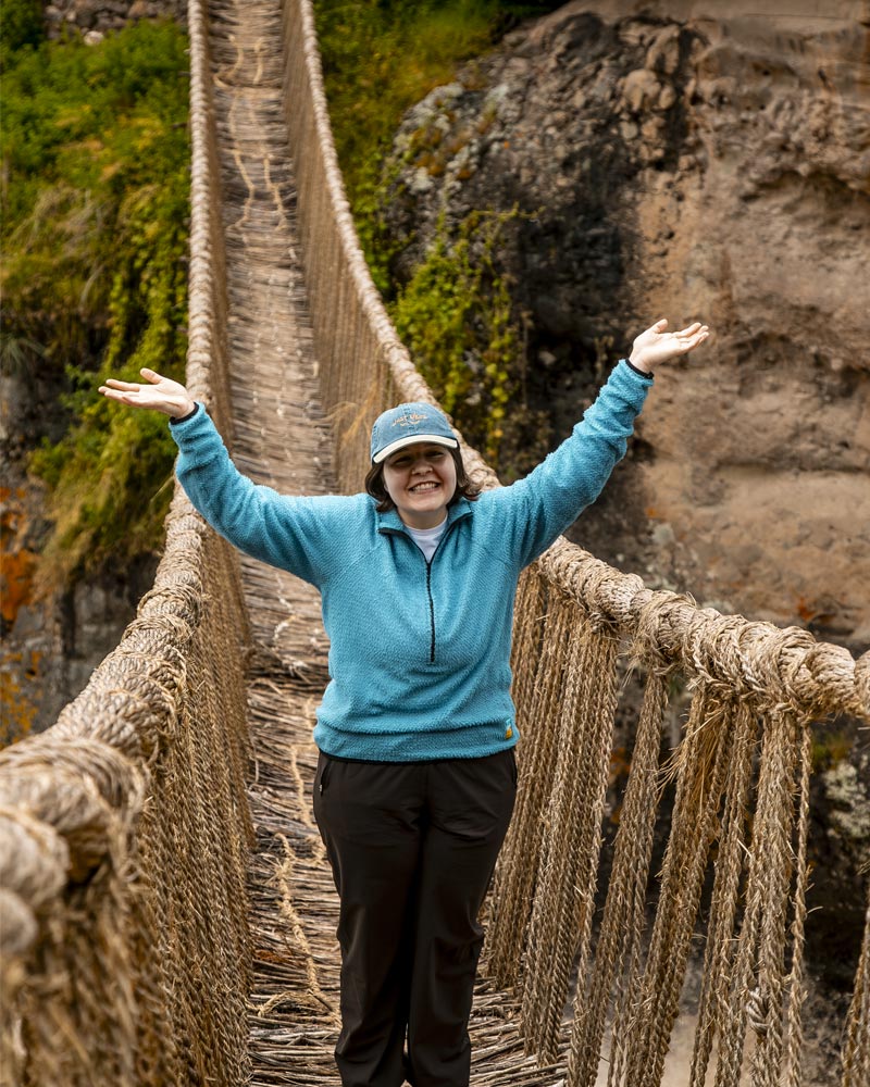 Tourist standing on the Inca bridge of Qeswachaka