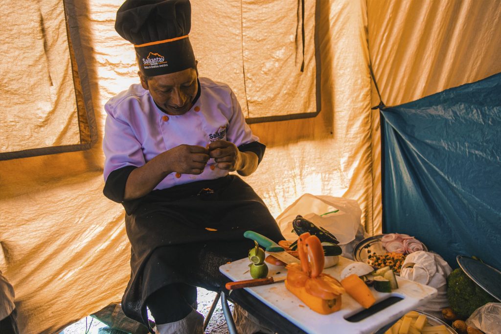 Cook in the process of preparing balanced meals on the Inca Trail