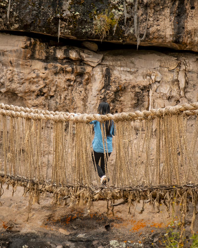 Tourist crossing the Inca bridge of Q’eswachaka