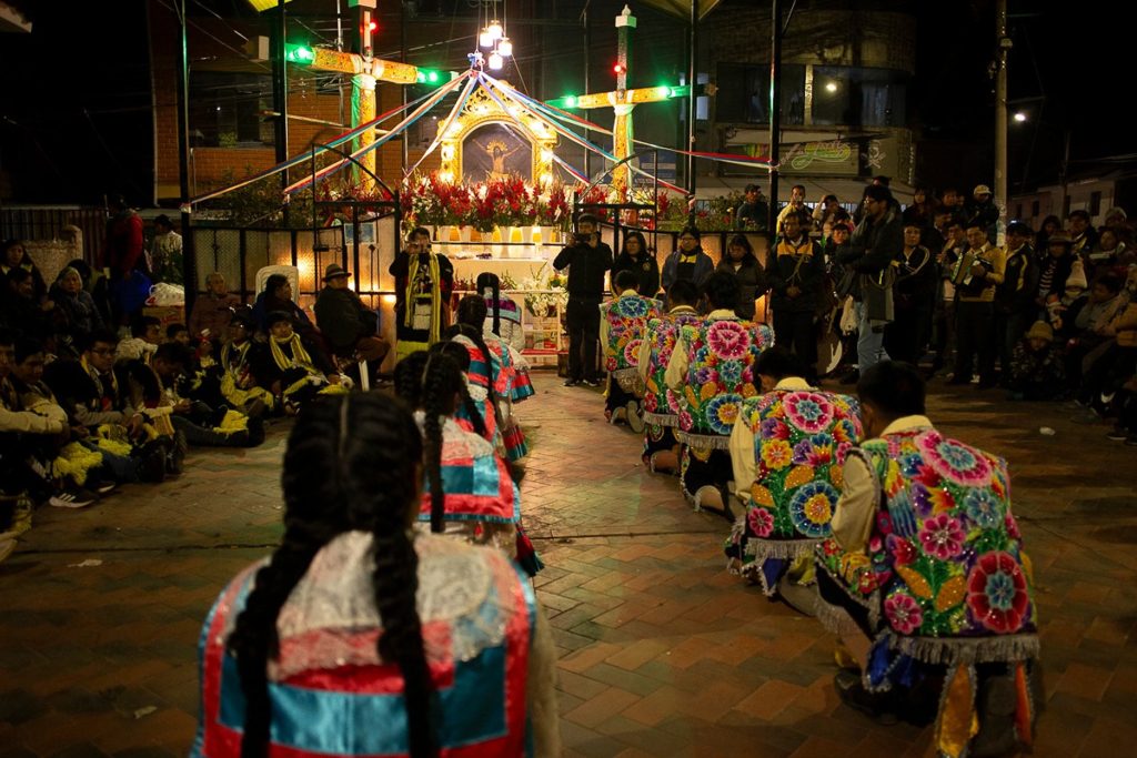Kneeling dancers at Cruz Velacuy in Cusco