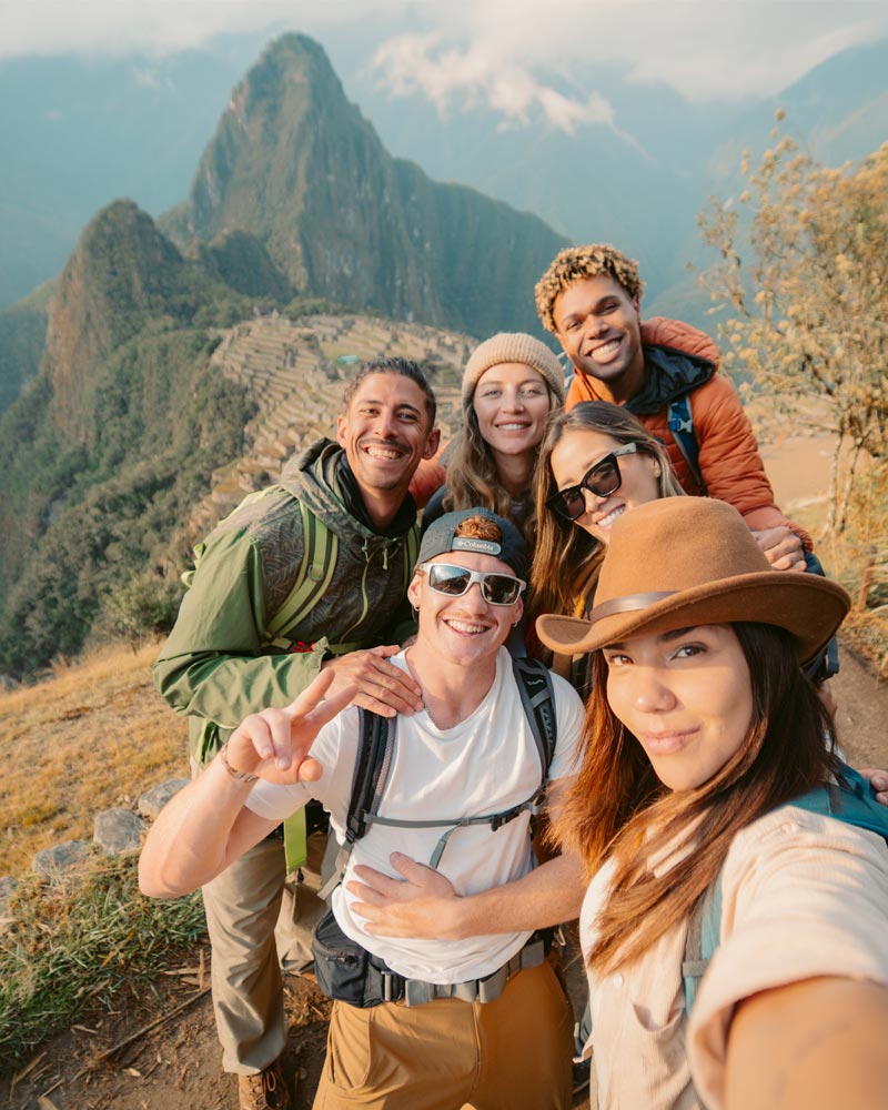 Selfi of a group of tourists at the archeological site of Machu Picchu