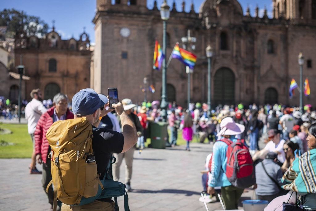 A tourist watching a festival in Cusco.