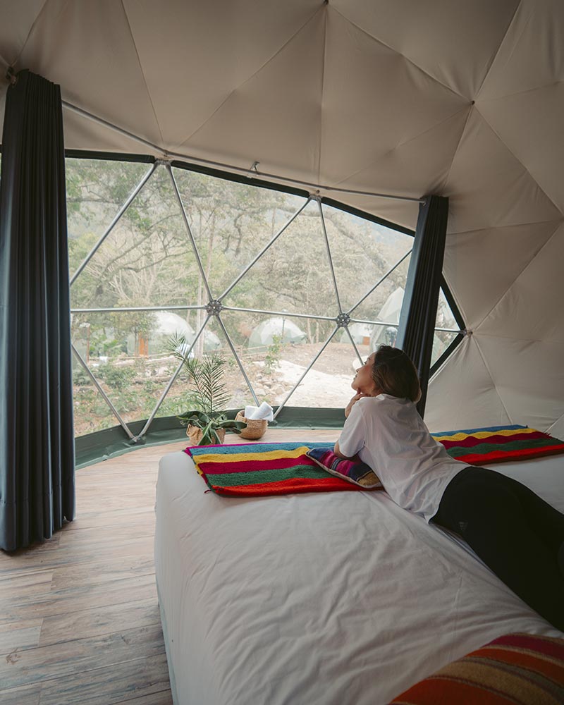 Tourist inside a dome of the Super Jungle Domes camp