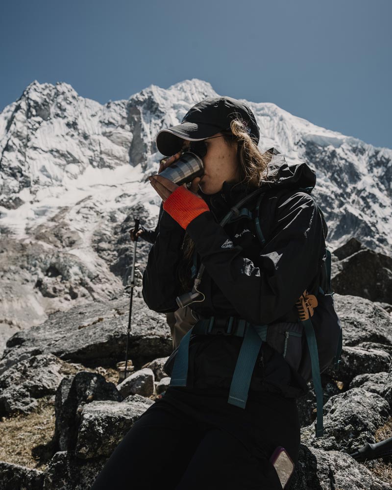 Tourist drinking coca tea at the Salkantay Pass.