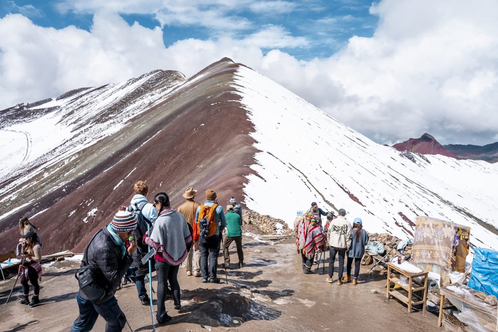Panoramic photo of tourist groups on the rainbow mountain of Vinicunca